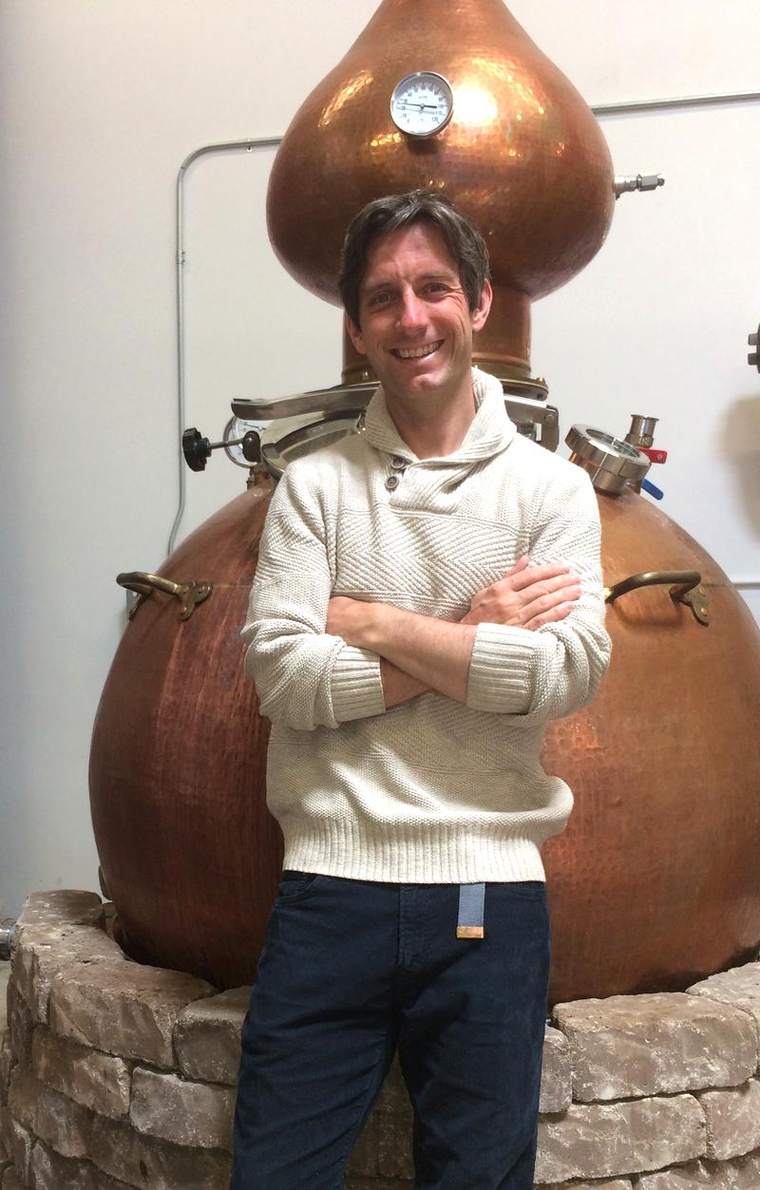 Ryan Max Riley beside the copper pot still